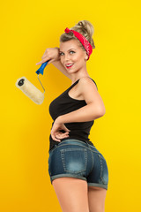 Young woman painting wall