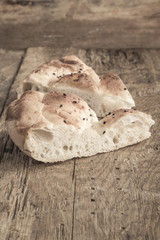loaf of pitta bread on wooden table