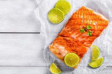 salmon fillet on a white parchment paper, top view