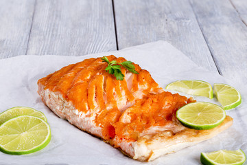 salmon fillet on a white parchment paper, close-up