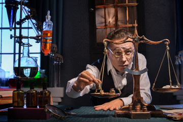 Pharmacist in a drugstore weighs powder