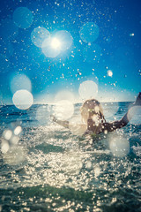 Happy child playing in the sea