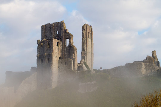 castle ruin in mist on sunny day
