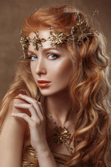 Beauty woman , red hair , professional make-up , gold color.