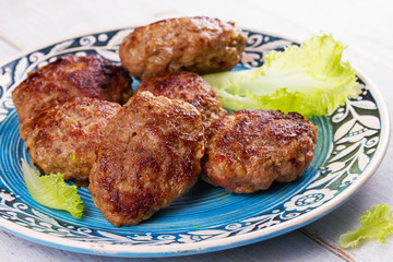 Beef and Pork Patties in Blue Plate.