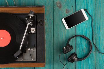 Vintage turntable, smartphone and headphones