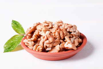 walnut kernels in a bowl on a table
