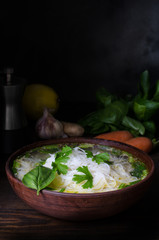 Thai chicken noodle soup, dark moody still life