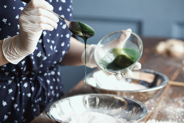 Preparation of bath bombs. Ingredients and floral decor on a wooden vintage table.