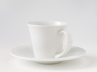 white cup and saucer