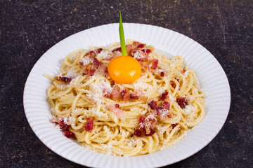 Carbonara pasta with raw egg, bacon and parmesan cheese