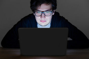 Guy with glasses hacking computer