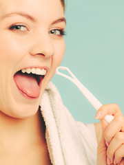 Girl with tongue cleaner.