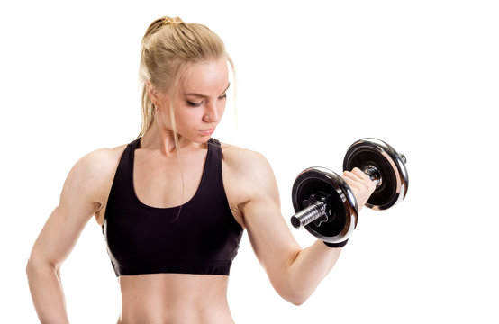 Young slim strong muscular woman posing in studio