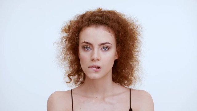 Scared girl bite her lips. Close up. Slow motion