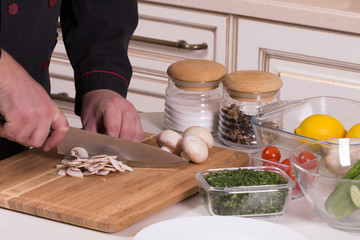 The chef cuts the mushrooms