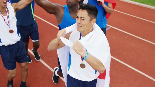  Group of athletes (disabled & able bodied) celebrate victory on running track
