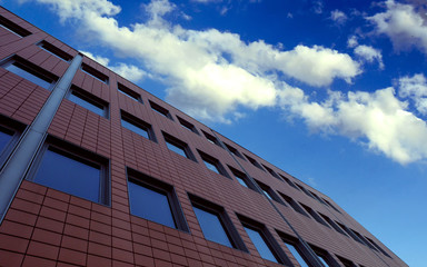 Fototapeta na wymiar Red Brick Building with Windows and Sky