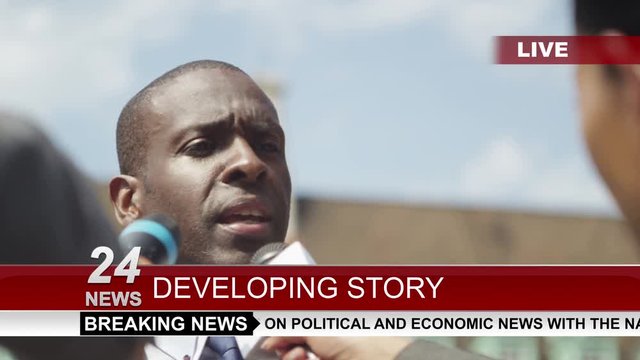  Businessman or politician giving live interview to news reporters
