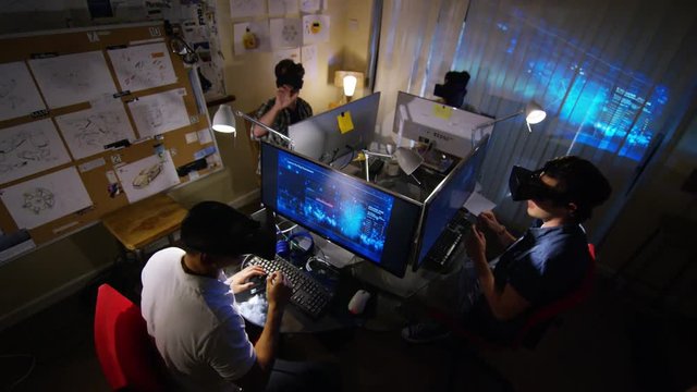  Group of young male computer gamers immersed in a virtual reality game