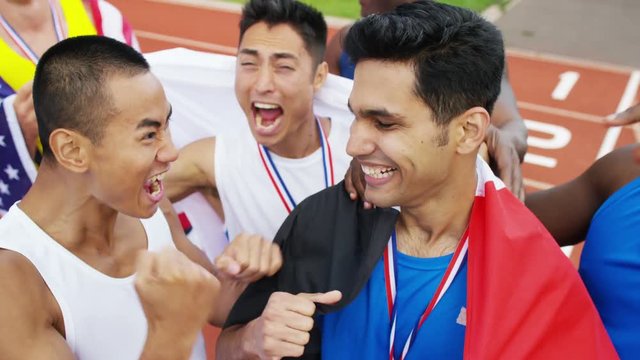  Group of athletes (disabled & able bodied) celebrate victory on running track