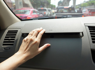  woman's hand press open drawer of the front of car