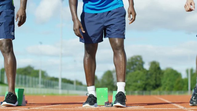  Portrait of black athlete getting into position at running track