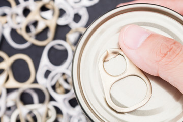 Woman hand holding ring pull cans opener background