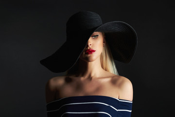 Beautiful woman in hat. Retro fashion beauty model girl with red lips