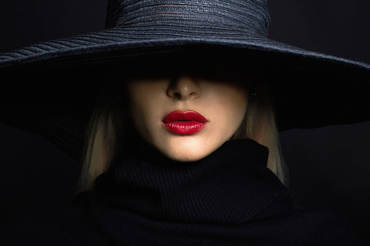 Beautiful woman in hat. face of girl in hat  over dark background
