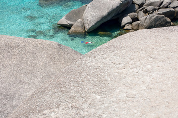 Man is swimming with snorkel and fins