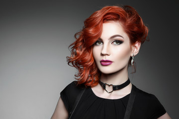 beautiful woman with red hair in a black dress