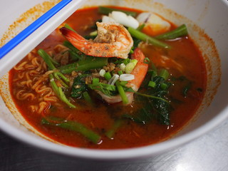 yellow noodle in spice seafood soup