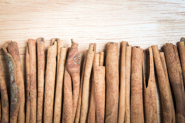 close up cinnamon stick arrange as a row as a background