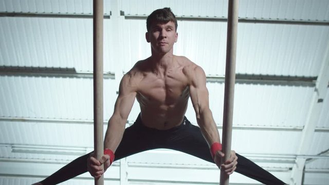  Professional male gymnast training on parallel bars at the gym