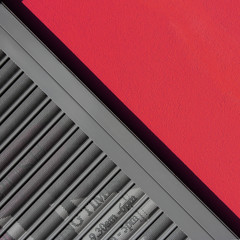 Diagonal offset shot of urban detail. Wall and shop shutter.