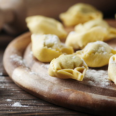 Italian traditional  tortellini on the wooden table