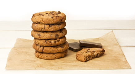Stack of chocolate chips cookies with pieces of chocolate
