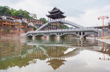 The Old Town of Phoenix (Fenghuang Ancient Town). The popular tourist attraction which is located in Fenghuang County. HuNan, China. Focus on bridge.