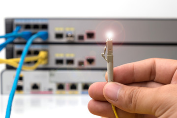 hand  holding optic fiber cables with connectors