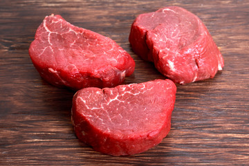 Fresh Raw Beef steak Mignon on wooden board.