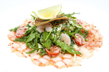 salad greens and shrimp meat on a white background