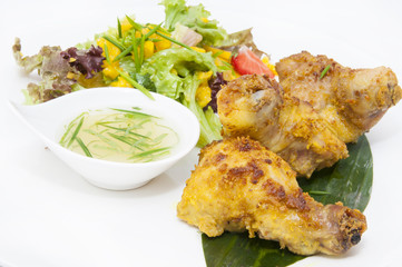 chicken in curry with salad and sauce on a white background in restorne