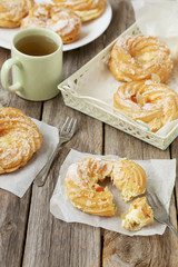 Sweet eclairs on a grey wooden table