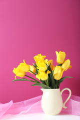 Bouquet of yellow tulips on a pink background