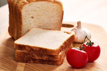 Toasts on the board and vegetables