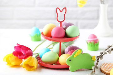 Easter eggs with cookies on a white wooden table