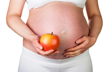 Pregnant woman with apple in hand isolated on white 