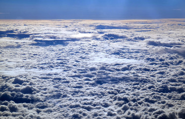 Clouds and sky as seen through window of an aircraft