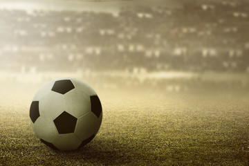 Fototapeta na wymiar Football or soccer ball on the stadium
